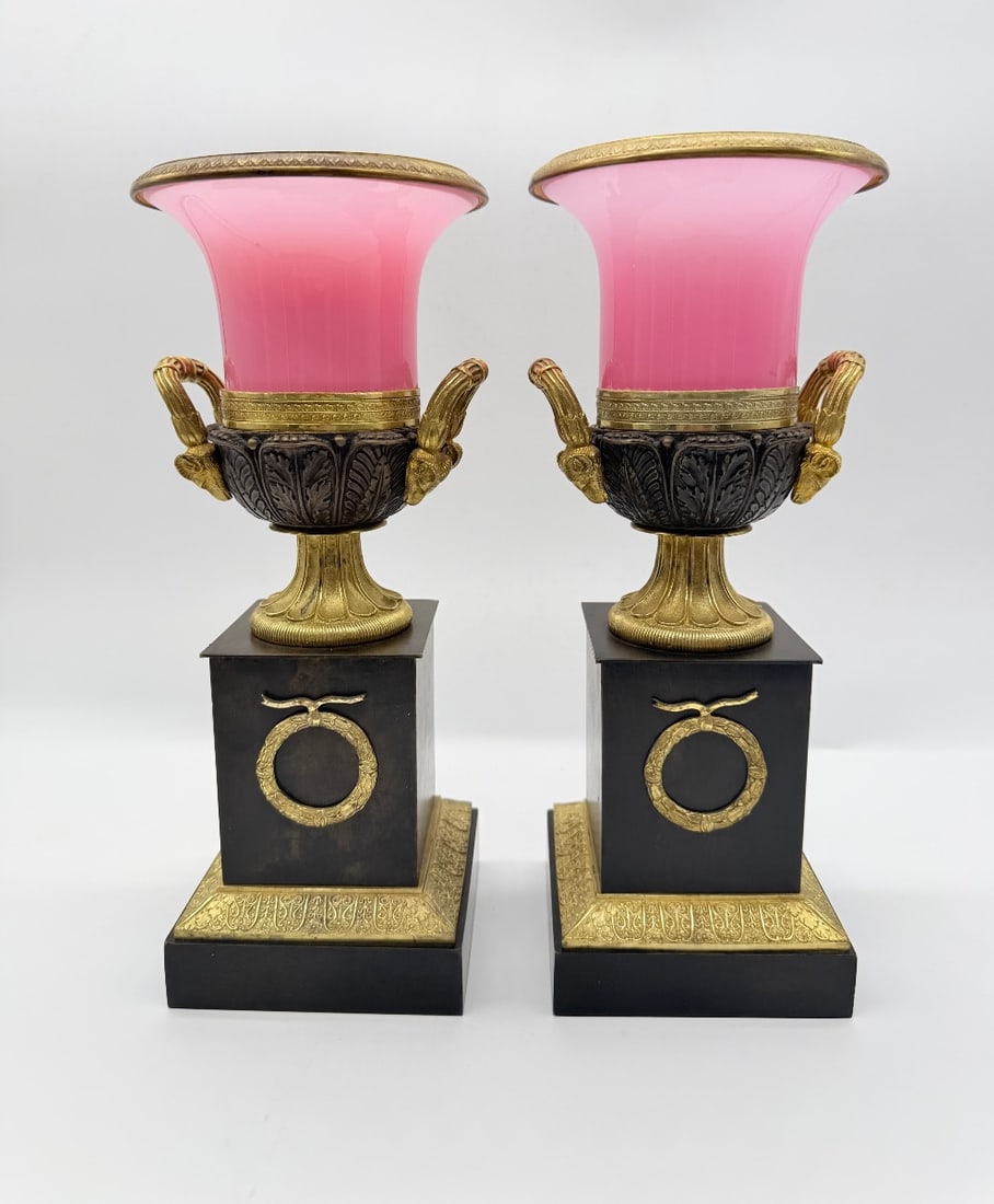 PAIR OF FRENCH "GORGE DE PIGEON" OPALINE AND GILT-BRONZE MEDICI VASES, RESTORATION PERIOD: A pair of French Restoration period Medici-form vases in gorge de pigeon pink opaline glass, mounted in chased gilt and patinated bronze. The flared opaline liners rest within patinated bronze bases c