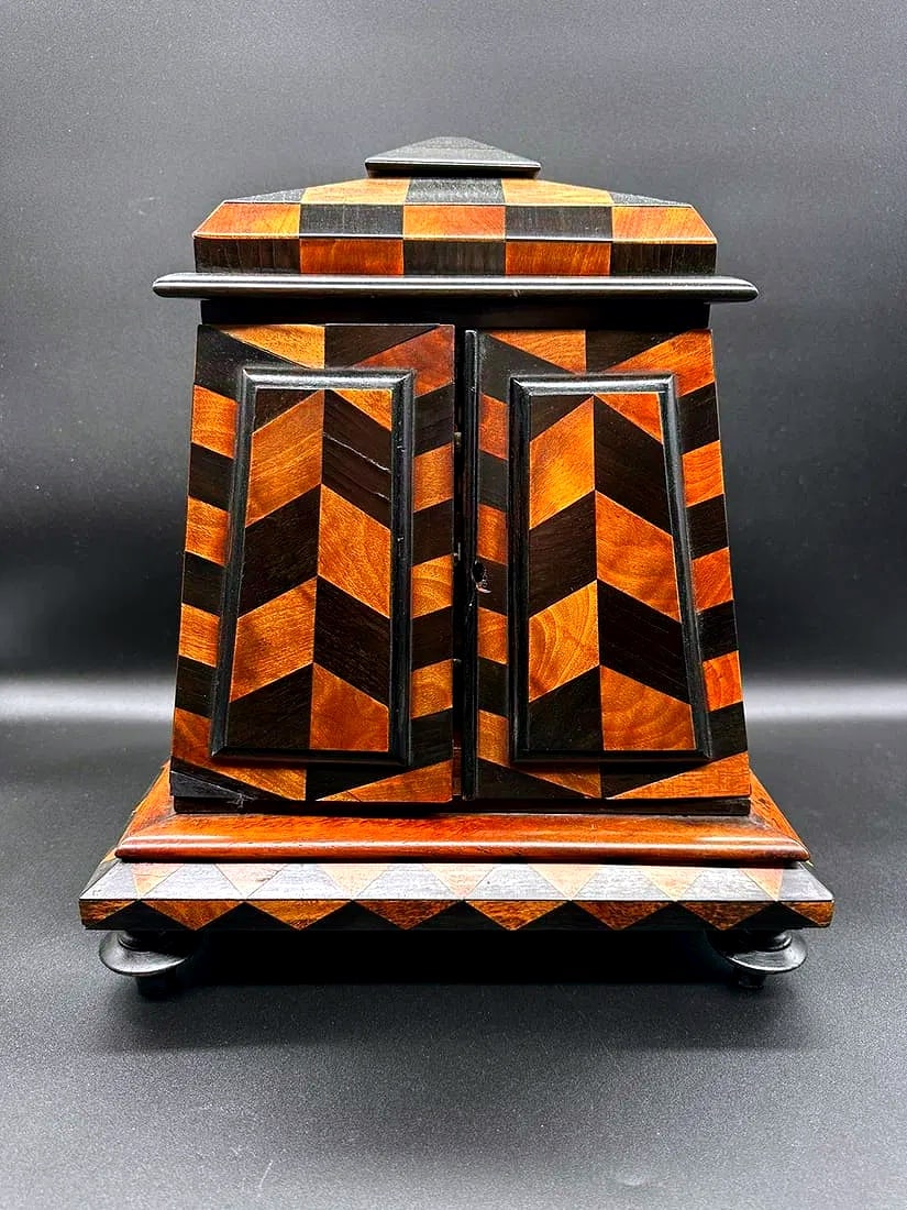 ITALIAN MARQUETRY TABLE CABINET OF ARCHITECTURAL FORM, GRAND TOUR, 19TH CENTURY: An Italian marquetry table cabinet constructed in rosewood, ebonized wood, and fruitwood in a tapered architectural form. The upper body features an angled, stepped top inlaid with a checkerboard patt