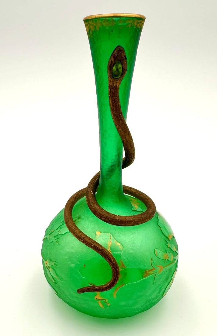 DAUM NANCY GREEN FROSTED GLASS SNAKE VASE. ART NOUVEAU PERIOD.: Frosted green glass vase with a spherical body and slender, tapering neck, featuring acid-etched and gilded floral decoration. The body is coiled by a detailed metal serpent sculpture whose head is se