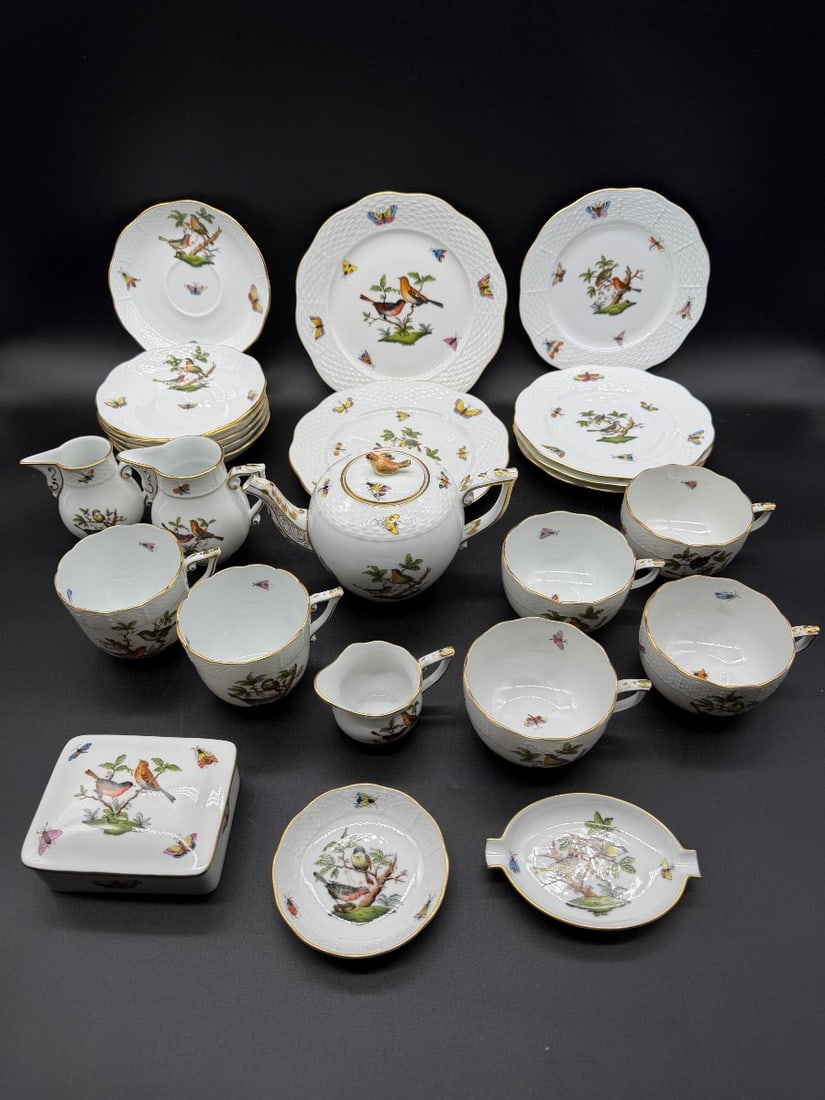 HEREND PORCELAIN TEA AND COFFEE SERVICE, ROTHSCHILD BIRD PATTERN: A 25-piece Herend porcelain service decorated in the Rothschild Bird (RO) pattern, featuring hand-painted birds perched on branches with insects and scattered butterflies, accented by gilt rims and os
