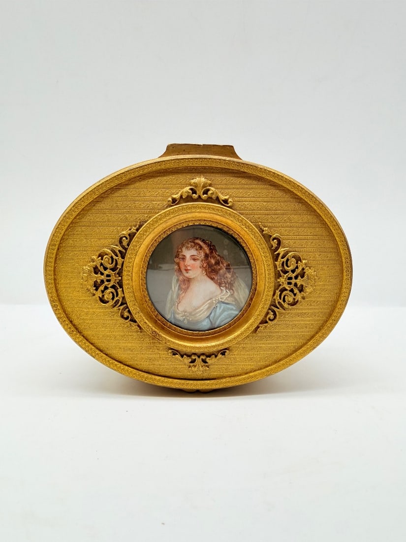 NAPOLEON III GILT BRONZE JEWELLERY CASKET WITH LIMOGES ENAMEL MINIATURE: A Napoleon III gilt bronze (ormolu) jewellery casket, finely chased and openworked with acanthus leaves, scrollwork, foliage volutes, and floral garlands. The hinged lid features a central Limoges ena
