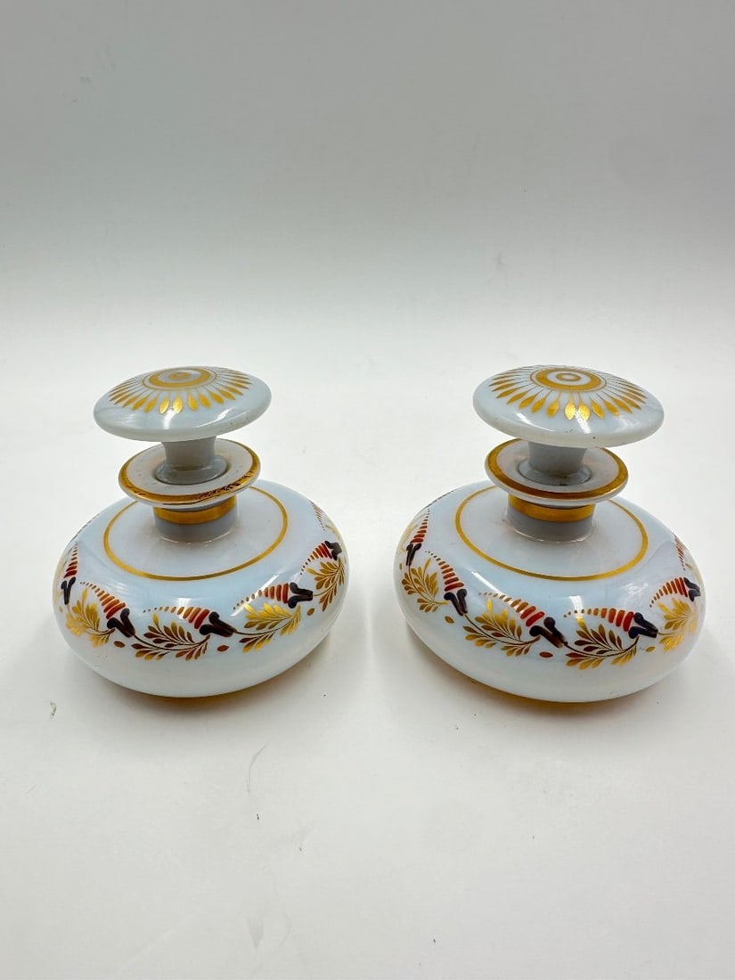 PAIR OF SOAPY WHITE OPALINE BOTTLES BY JEAN-BAPTISTE DESVIGNES: Jean-Baptiste Desvignes (1786–1826)A pair of "soapy" white opaline glass perfume or toilet bottles with original mushroom-shaped stoppers. Hand-painted in cold enamel and gilt using the proprietary 