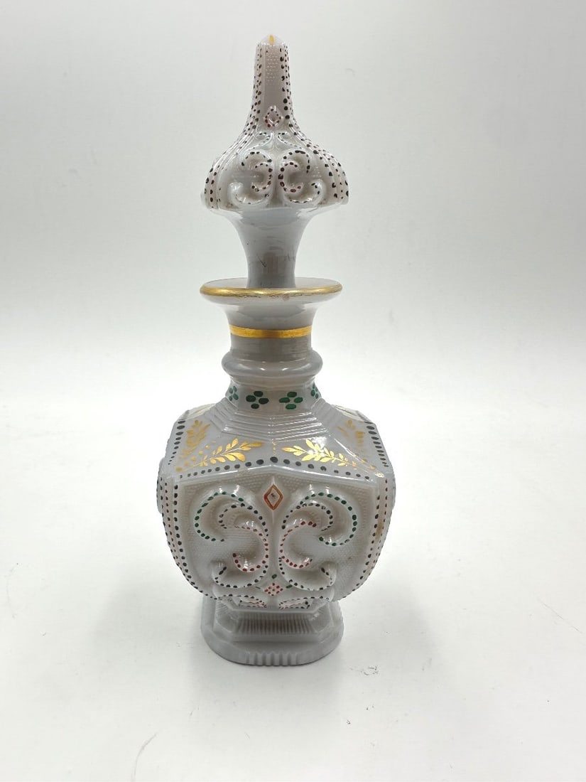 19TH CENTURY WHITE OPALINE GLASS SCENT BOTTLE FOR THE OTTOMAN MARKET: A French white opaline glass scent or perfume bottle featuring molded relief scrollwork and gilt accents. Decorated with polychrome enamel beaded dots (perles) in red and green, gilt foliage along the
