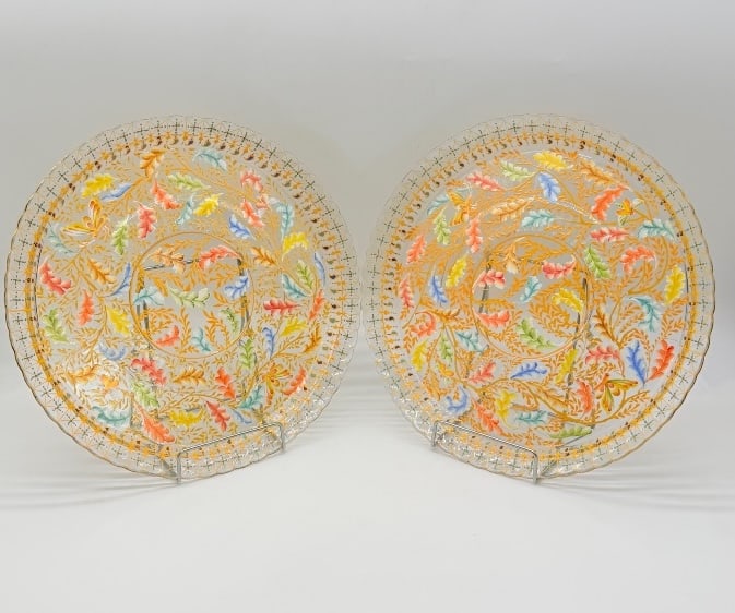 PAIR OF MOSER ENAMELED GLASS SERVING PLATES: A large pair of clear glass serving plates decorated in Moser's signature late 19th-century enamel style. Each plate features hand-applied polychrome enamel oak leaves in shades of orange, yellow, blu