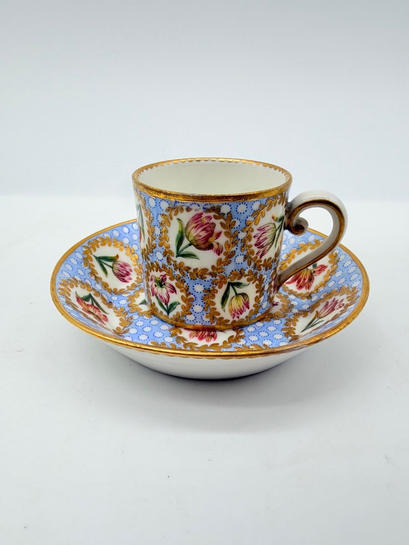 18TH-CENTURY SÈVRES PORCELAIN CUP AND SAUCER ("GOBELET LITRON"): An 18th-century soft-paste Sèvres porcelain coffee cup and saucer (gobelet litron et sa soucoupe). Featuring a light blue œil-de-perdrix ground, the set is decorated with repeating oval medallion re