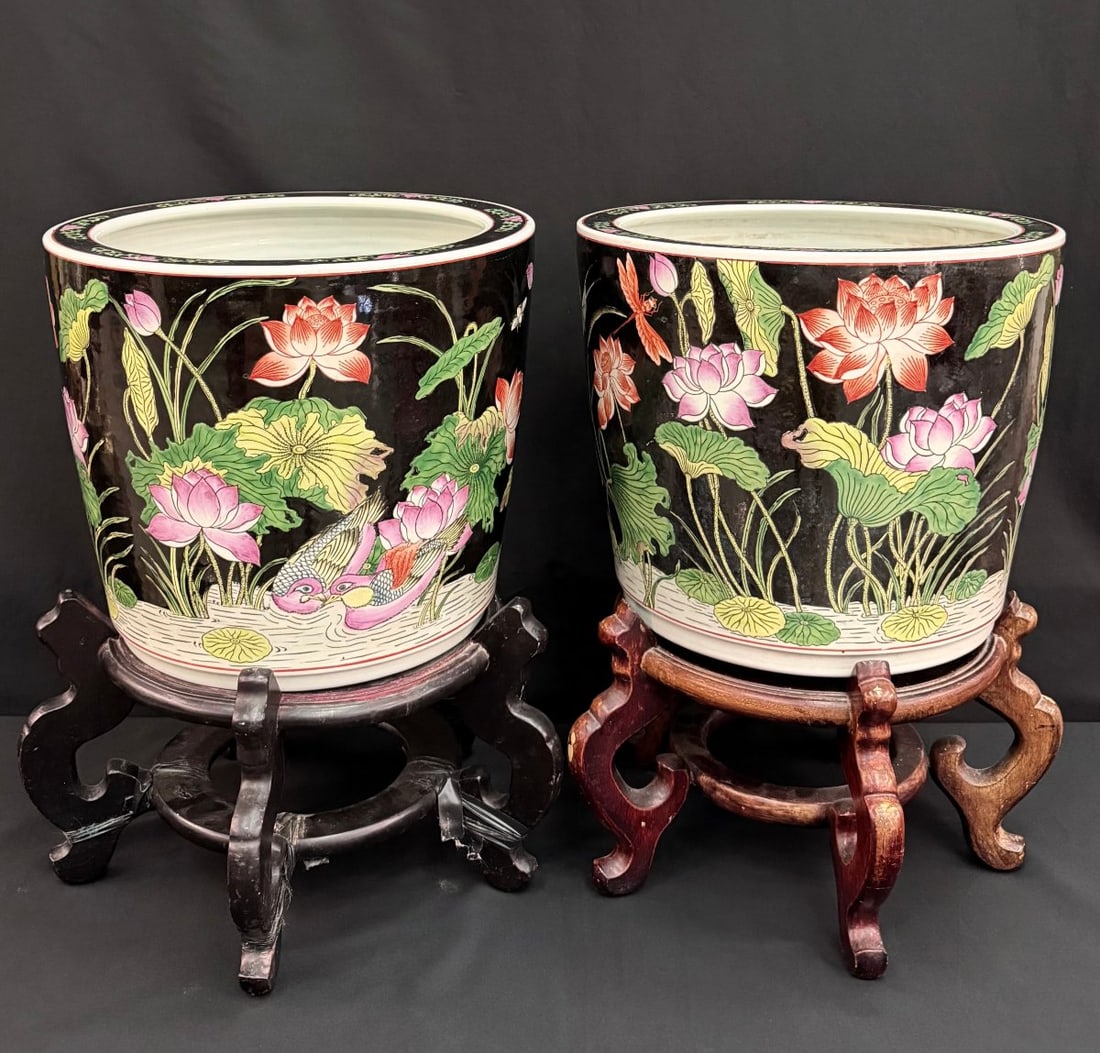 Pair Of Large Black-ground Porcelain Jardinieres In The Famille Rose Style, China, 20th Century: Pair of large porcelain cache?pots with black ground in the Famille Rose taste, richly decorated in polychrome enamels with mandarin ducks swimming among blooming lotus ponds; circular stained and car