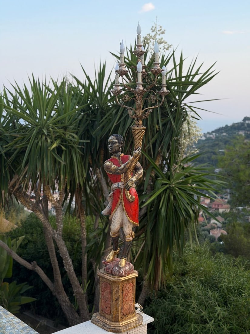 Large Candlestick With A Venetian Moretto Figure, Venice, Late 19th Century: Large parterre torch holder (or ‘guéridon-mordieu’) depicting a Moorish gondolier, carved from wood, polychromed and partially gilded, holding a twisted torch surmounted by a six-armed light fixt