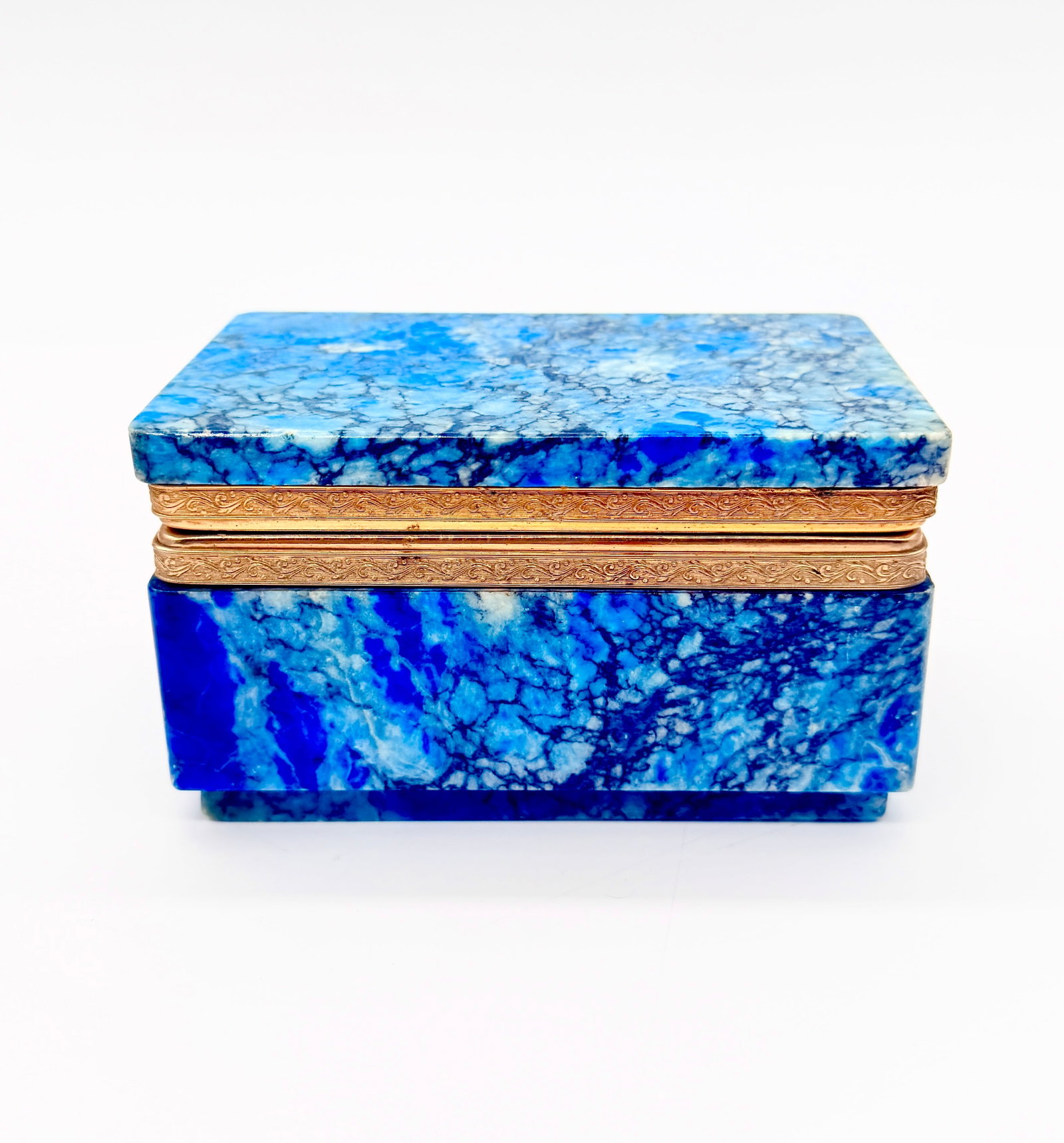 19TH-CENTURY BLUE MARBLE BOX WITH GILT BRONZE MOUNT: An antique rectangular trinket box finely crafted from vibrant blue marbled stone with natural white and dark veining. Fitted with a chased gilt bronze (ormolu) hinged rim mount decorated with delicat