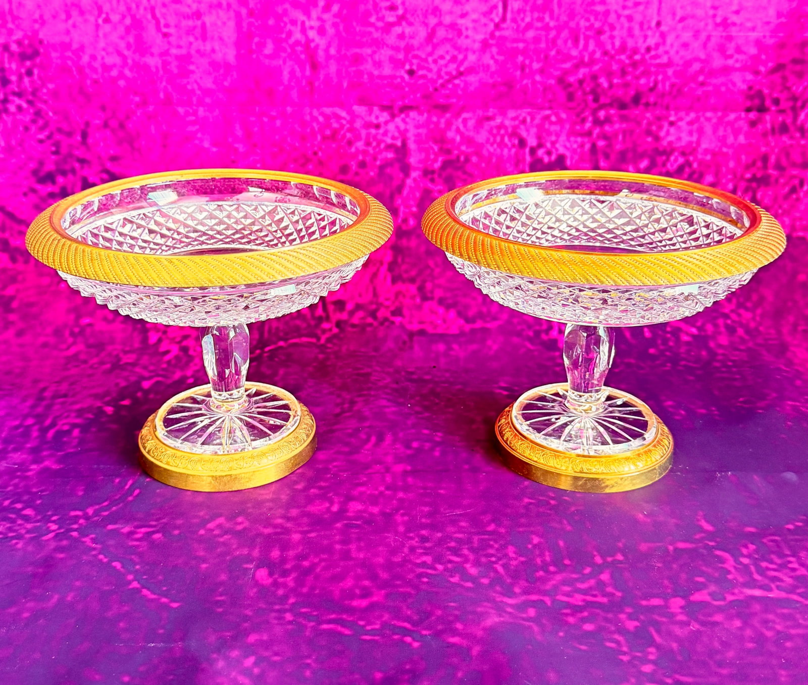 CHARLES X PAIR OF FRENCH BACCARAT CUT CRYSTAL TAZZA WITH GILT BRONZE MOUNTS: Pair of footed crystal dish (tazza or comport) featuring fine diamond-point geometric cut crystal. The shallow basin is finished with a gadrooned gilt bronze (ormolu) rim and rests on a faceted stem w