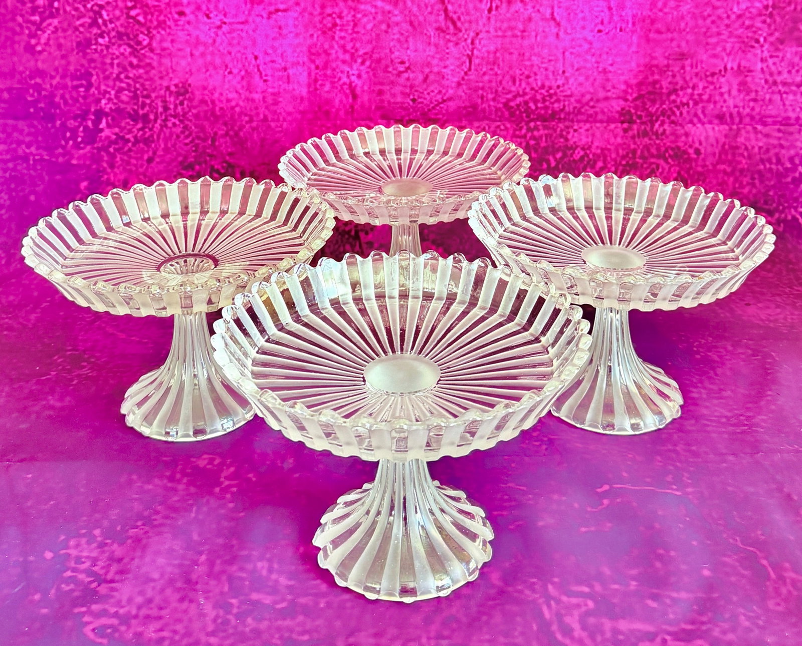 BACCARAT FROSTED AND MOLDED CRYSTAL PEDESTAL BOWL SET. SIGNED: A set of four Art Deco period clear and frosted molded crystal pedestal bowls (compotiers) by Baccarat. Features a fluted dish with a scalloped edge supported by a matching fluted flared stem, decorat