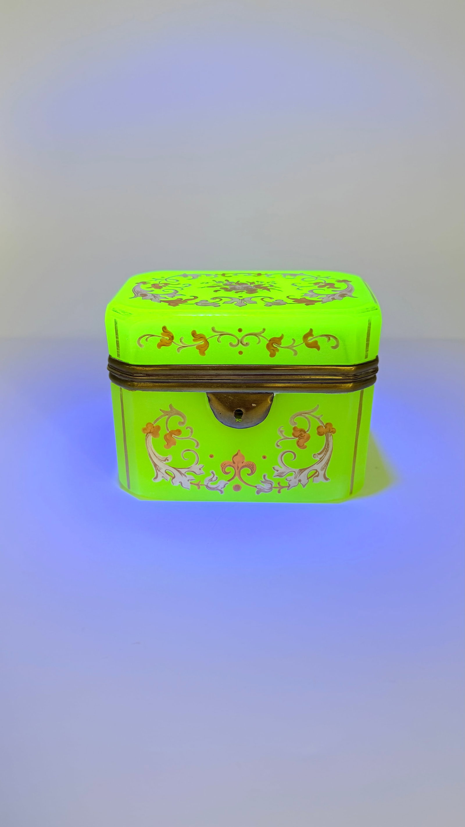 BOHEMIA URANIUM GLASS BOX FOR OTTOMAN MARKET 19TH CENTURY: Rectangular hinged box or trinket casket in fluorescent apple-green uranium opaline glass (ouraline), illuminated under UV light. Hand-painted with delicate gold and silver scrolling foliate motifs, f