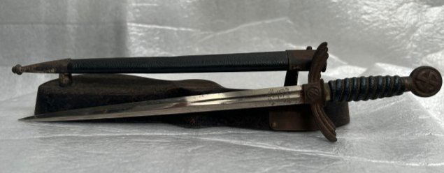 EXTRAORDINARY RARE RELIC FROM WW11 & NAZI GERMANY ERA NAZI DAGGER ALCOSO SOLINGEN: EXTRAORDINARY RARE RELIC FROM WW11 & NAZI GERMANY ERA A NAZI DAGGER ON A CAST IRON STAND , THERE IS A SMALL PLATE WITH HARD TO READ WORDS IN GERMAN, NAZI SIGNS ON THE HANDLE OF THE SORD , ON THE BLADE