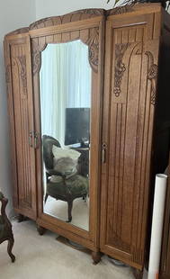 Antique art deco French armoire from Paris with original key: This antique French armoire is a true beauty from the early 1900s, originating from Paris with its original key intact. The armoire is handmade and has a total of four shelves to store your belongings