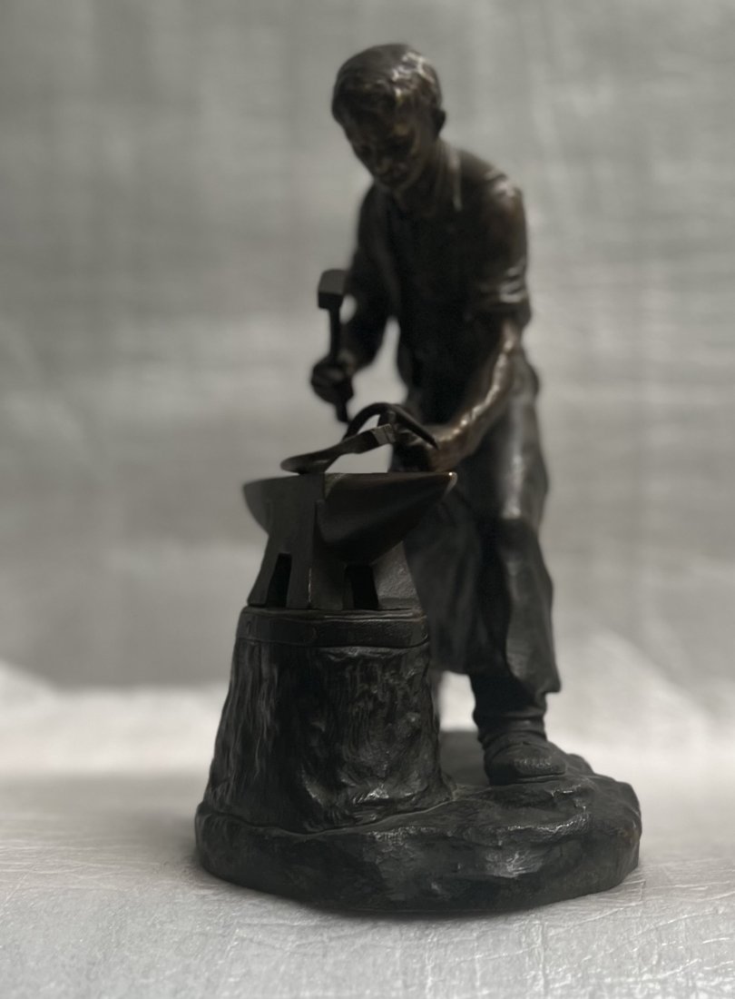 EDOUARD DROUOT BRONZE SCULPTURE "A BLACKSMITH AT WORK" SIGNED AT THE BASE: Enhance your art collection with this stunning sculpture by Edouard Drouot (1859-1945) Fench. This beautiful piece depicts a blacksmith hard at work, and is made of the finest quality bronze. It is si