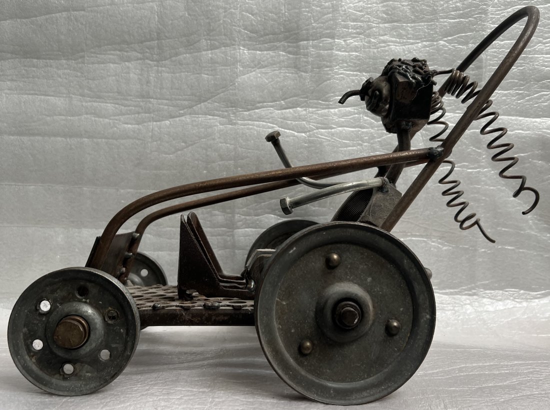 Artisan made iron Race Car sculpture by Dan Whitbeck. Signed/dated. Made in USA: This exquisite sculpture by Dan Whitbeck is the perfect addition to any art collection. Handmade with iron, this race car statue showcases the artist's exceptional talent and attention to detail. The 