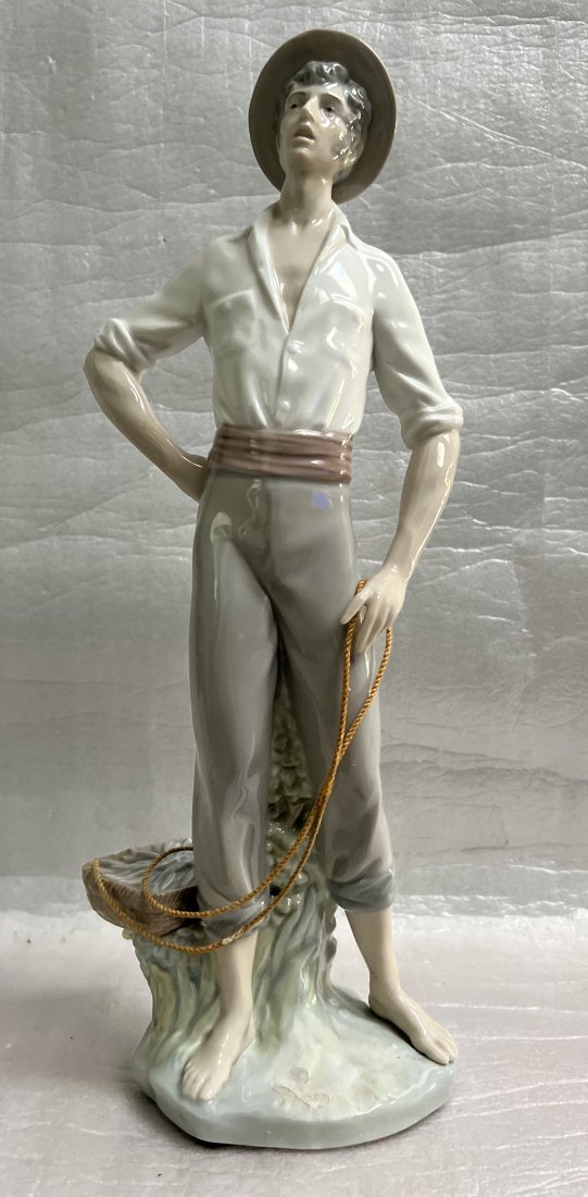 LLADRO "THE FISHERMAN" HOLDING THE CATCH OF THE DAY , # 4802: This beautiful sculpture is a masterpiece made by LLADRO, a renowned artist from Spain. The piece depicts a fisherman holding the catch of the day, and it stands at 15 inches tall. It is a medium-size