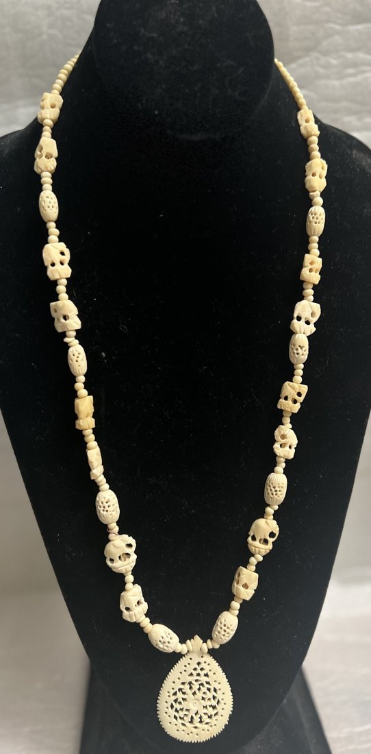 NECKLACE ITALIAN CARVED BONE NECKLACE W PENDENT FROM A RETIRED DEALER 26": This beautiful Italian necklace is a unique piece of jewelry that will add charm and elegance to your collection. Made of carved bone, it has an ivory color and a beaded style. The necklace is 26 inch
