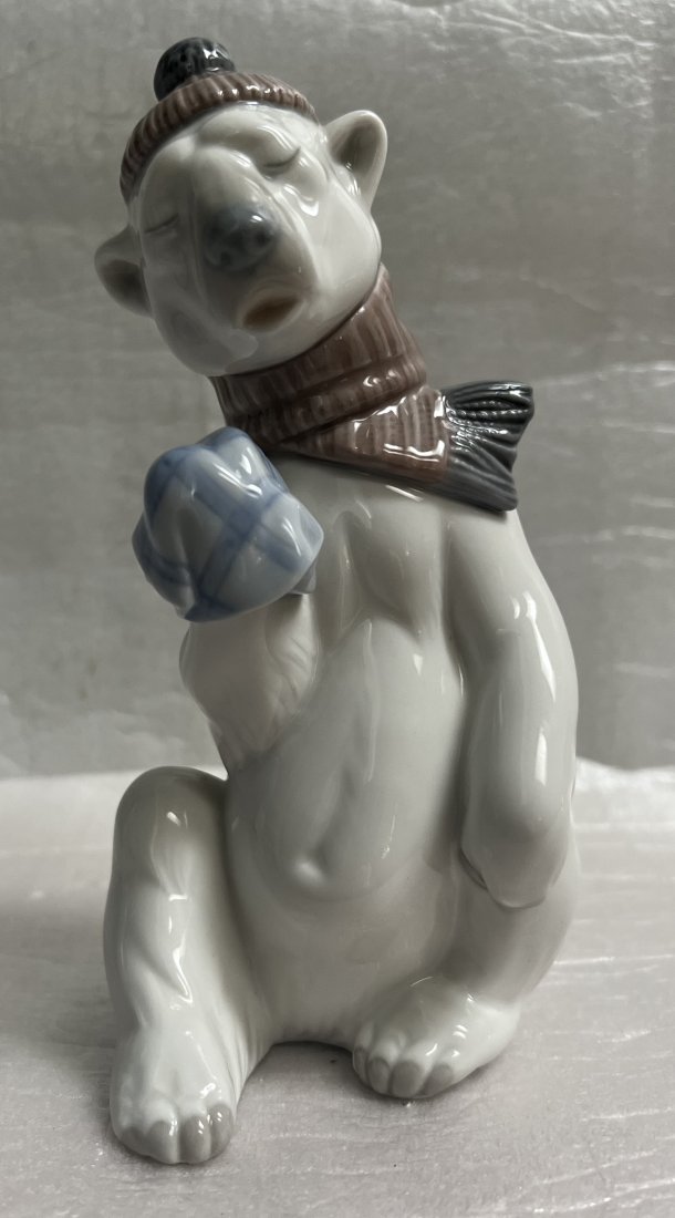 LLADRO NUMBER 5021 "PAINFUL BEAR" POLAR BEAR WITH SCARF & HAT PORCELAIN FIGURINE: This beautiful sculpture by LLADRO features a Polar Bear with a scarf and hat. The piece is made from high-quality porcelain and is an original, not a licensed reproduction. The bear is depicted in a