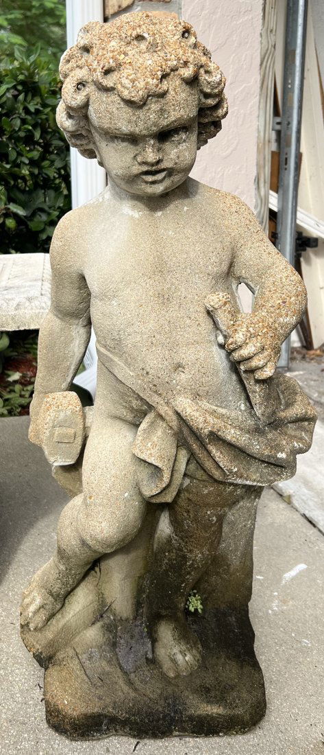 A WEATHERED CEMENT GARDEN STATUE  " A PUTTO WITH A HAMMER AND CHISEL" (1 of 3)
