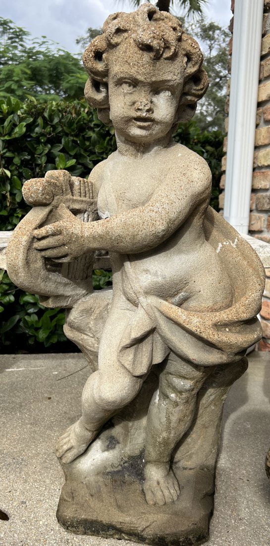 A WEATHERED CEMENT GARDEN STATUE  " A PUTTO WITH A HARP" (1 of 3)