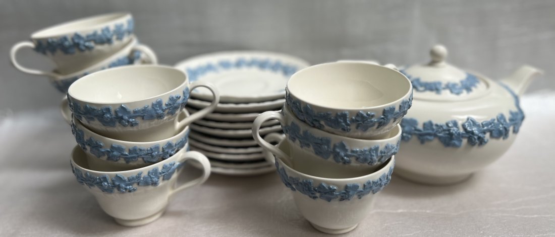 WEDGEWOOD EMBOSSED QUEENS WARE SET OF 10 TEA CUP, SAUCERS & KETTLE: Indulge in a timeless tea experience with this exquisite set of ten Wedgewood bone china tea cups and saucers. Delight in the embossed floral design that exudes elegance and sophistication. This vinta