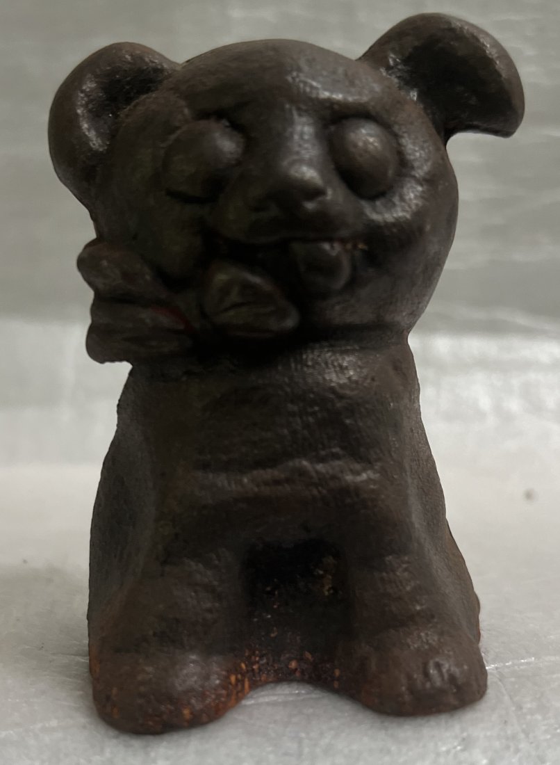 CAST IRON BROWN PUPPY DOG COIN BANK BOW TIE ANTIQUE CIRCA EARLY 20TH C 4" TALL: This charming cast iron puppy dog coin bank with a bow tie is an original antique, believed to be from the early 20th century. It stands at 4 inches tall and is a delightful addition to any collection