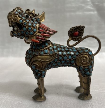 VINTAGE TIBETAN FOO DOG WITH TURQUISE & CORAL STONES: This vintage Tibetan Foo Dog figurine is a stunning piece of art that boasts intricate details and beautiful craftsmanship. Made of stone and adorned with turquoise and coral stones, this figurine is 