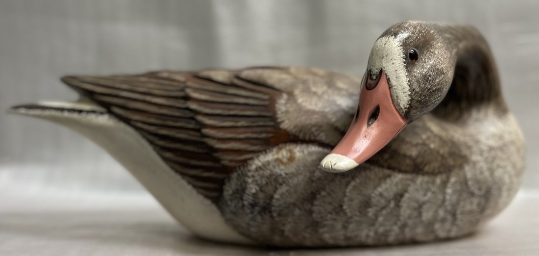 MAX THOMPSON HAND CARVED FROM WOOD "WHITE FRONT GOOSE" HAND SIGNED: This hand-carved sculpture by Max Thompson captures the beauty of American wildlife through his intricate carving technique. The statue features a white front goose, with details so lifelike you can a