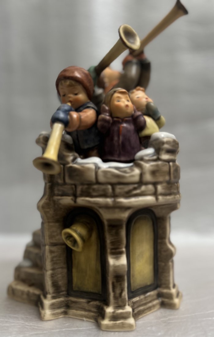 GOEBEL "FANFARE " CERAMIC STATUE M.J.HUMMEL SERIES 11" T 7" W 6" D: This beautiful ceramic statue from the M.J. Hummel series is a must-have for any collector. The Goebel brand is well-known for their high-quality figurines, and this one depicting children with horns