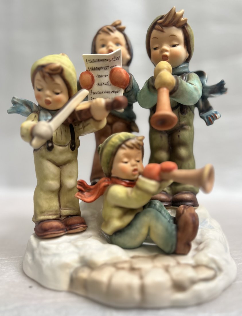 GOEBEL "STRIKE UP THE BAND " CERAMIC STATUE M.J.HUMMEL SERIES 7" T 6" W 5" D: This Goebel ceramic statue from the M.J. Hummel series is a stunning addition to any collection. With a height of 7 inches and dimensions of 6 inches in width and 5 inches in depth, this statue is the