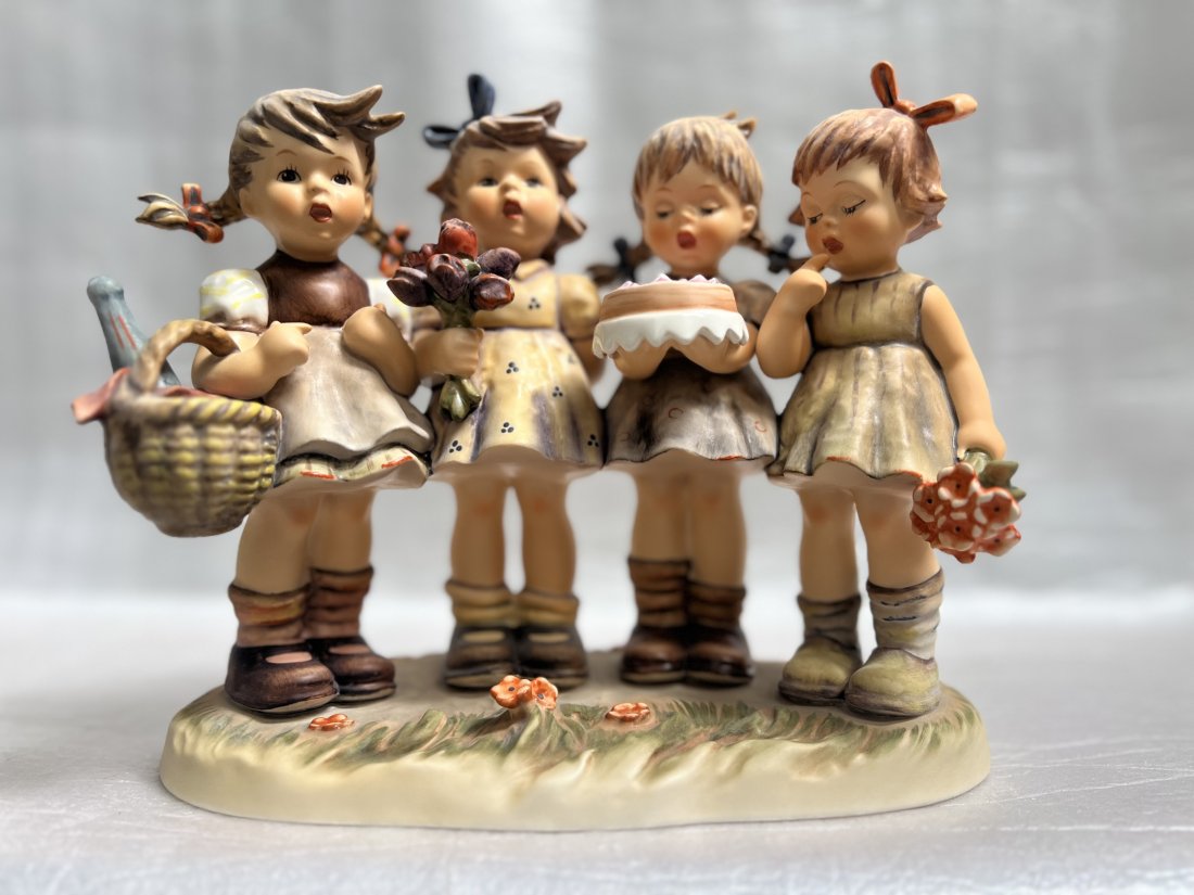 GOEBEL HUMMEL “WE WISH YOU THE BEST" # 600 Century Collection TMK6 8.25" SIGNED: This beautiful GOEBEL HUMMEL figurine is a part of the Century Collection and is signed by the artist. The piece depicts four children holding a basket, flowers & cake the piece is called "We Wish You