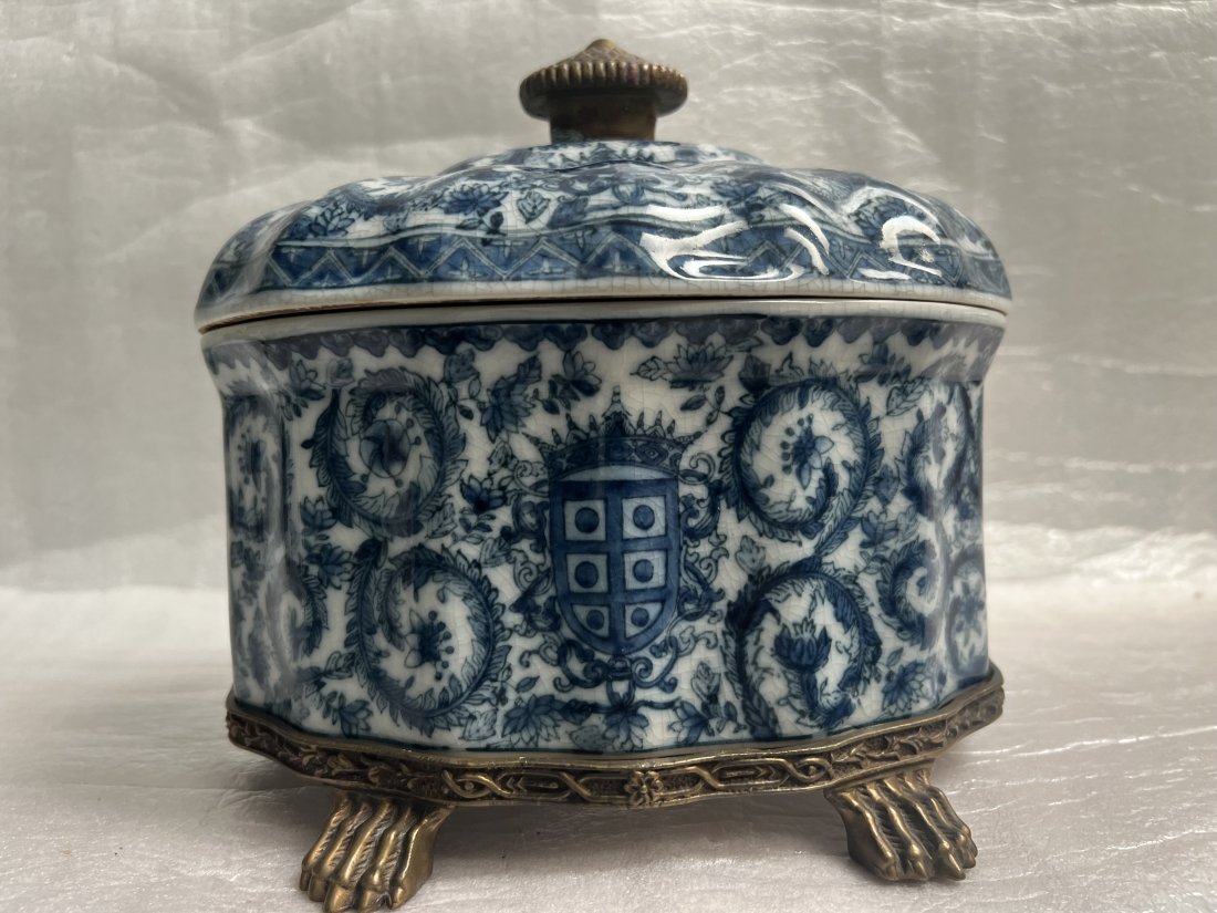 CASTILIAN PORCELIAN VINTAGE BLUE AND WHITE BOWL WITH LID WITH BRONZE STAND: Add a touch of vintage to your dining table with this beautifully crafted CASTILIAN porcelain bowl. The oval bowl comes with a lid and a bronze stand, making it a perfect centerpiece for any occasion.