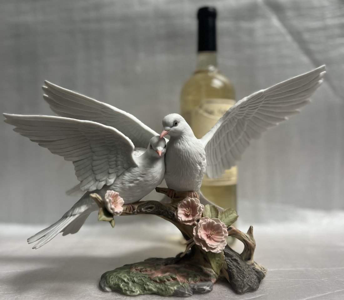 VINTAGE PORCELAIN MURURI "WINGS OF LOVE" PORCELAIN, HAND PAINTED: This beautiful figurine by MURURI features the theme of "Wings of Love". Handmade with care, the medium-sized piece stands at a height of 8.5 inches and has a width of 13 inches. The delicate porcelai