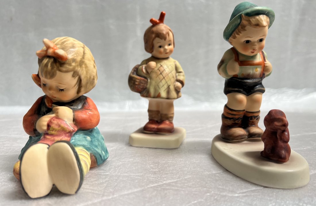 LOT OF THREE GOEBEL FIGURINE, "KNIT ONE PURL ONE""SENSITIVE HUNTER" & "I BOUGHT YOU A GIFT": LOT OF THREE GOEBEL FIGURINE, "KNIT ONE PURL ONE""SENSITIVE HUNTER" & "I BOUGHT YOU A GIFT" Each figurine is beautifully crafted with intricate details and made from high-quality porcelain. The collec