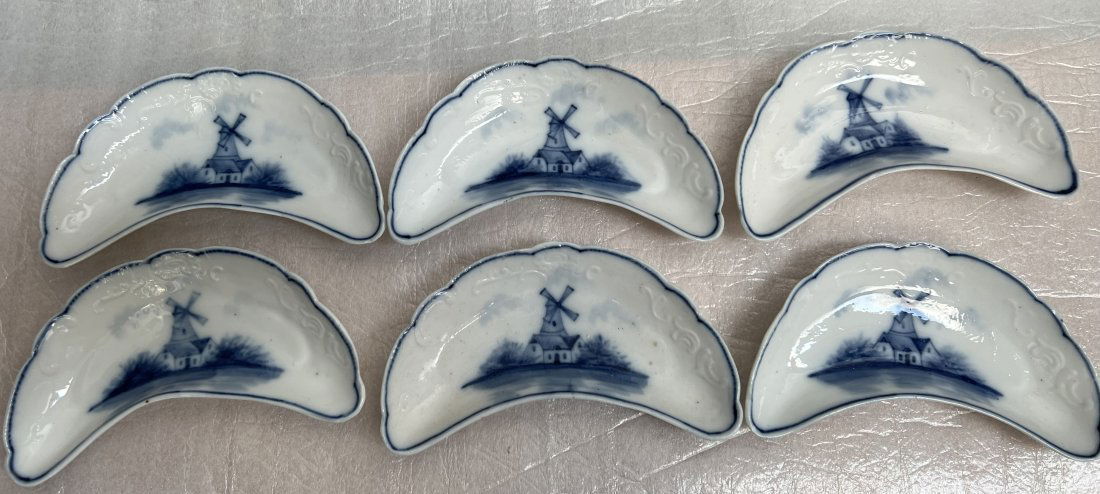 Set of 6 Vintage Bone Dishes Blue White Windmill Scene Hand Painted Made in Germany: This set of six vintage bone dishes is a delightful addition to any dining table. The dishes feature a beautiful hand-painted blue and white windmill scene and are made of high-quality porcelain. They