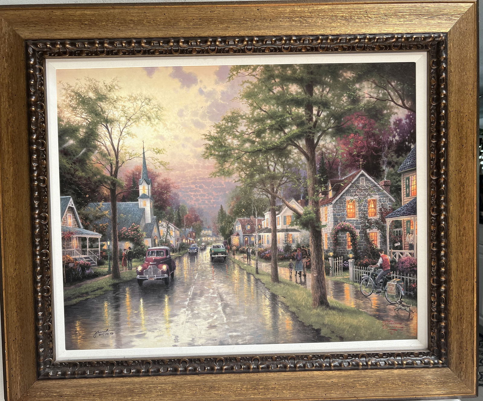 Thomas Kinkade "Hometown Morning" Embellished Giclee on Canvas: This beautiful giclee painting by Thomas Kinkade depicts a serene and peaceful morning in a small town. The artwork is embellished on canvas and is a large size measuring 35 inches high and 40 inches