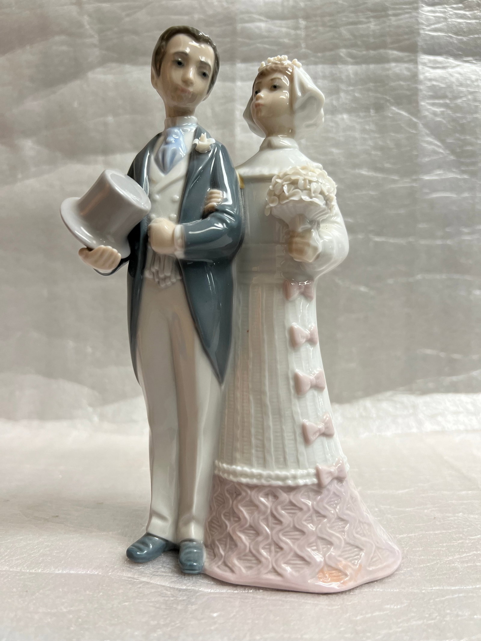 LLADRO Wedding Bride and Groom Porcelain Figurine #4008 Retired: This beautiful Lladro porcelain figurine, model #4008, depicts a lovely wedding scene with a bride and groom. The glossy finish adds a touch of elegance to this collectible piece, which was manufactur