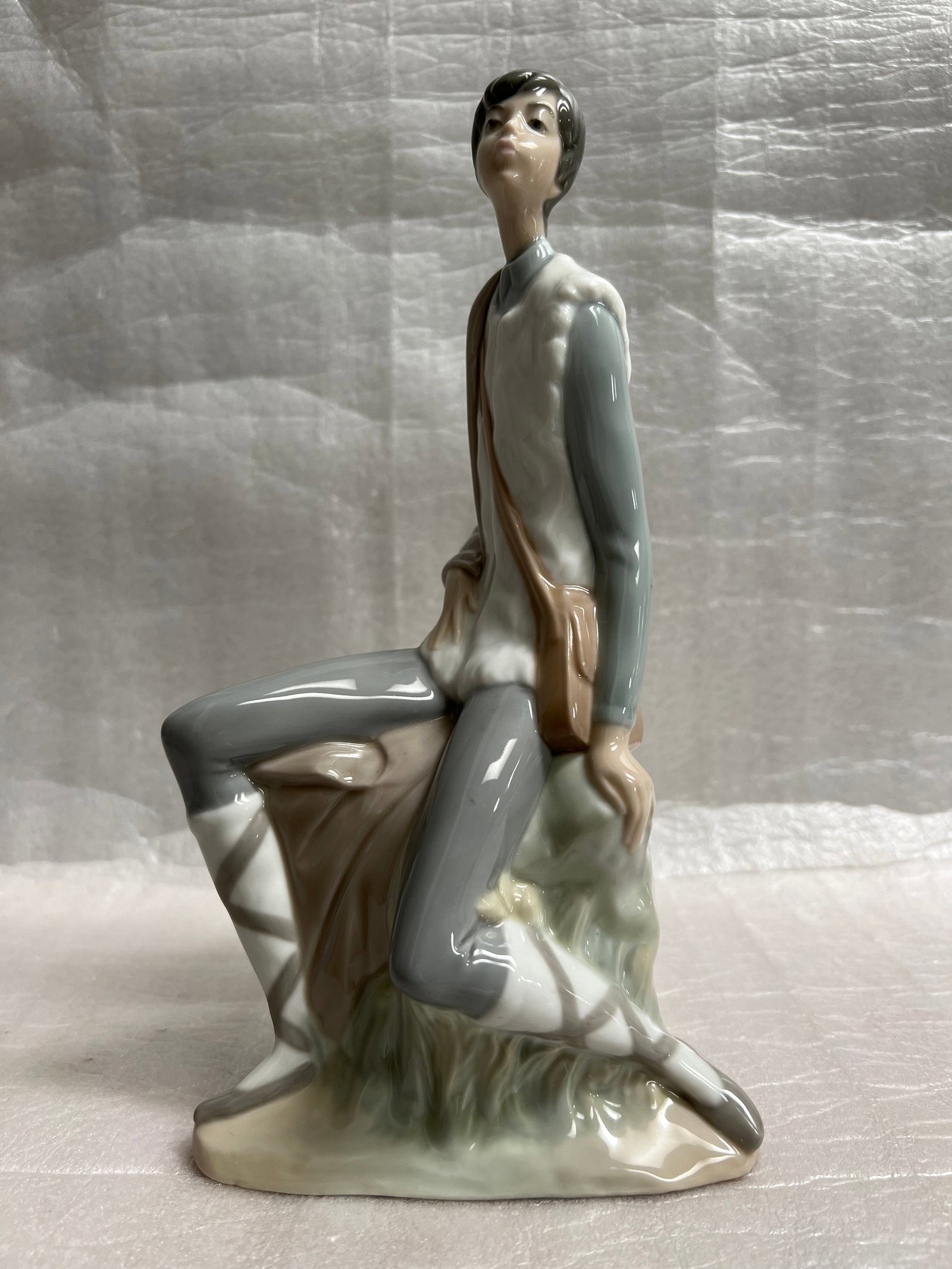 Lladro- Nao "Pastorello" Porcelain Figurine from Spain: This beautiful Lladró porcelain figurine from Spain features a charming design that's perfect for all occasions. The medium-sized figurine depicts a Pastorello and is brightly colored with a polished