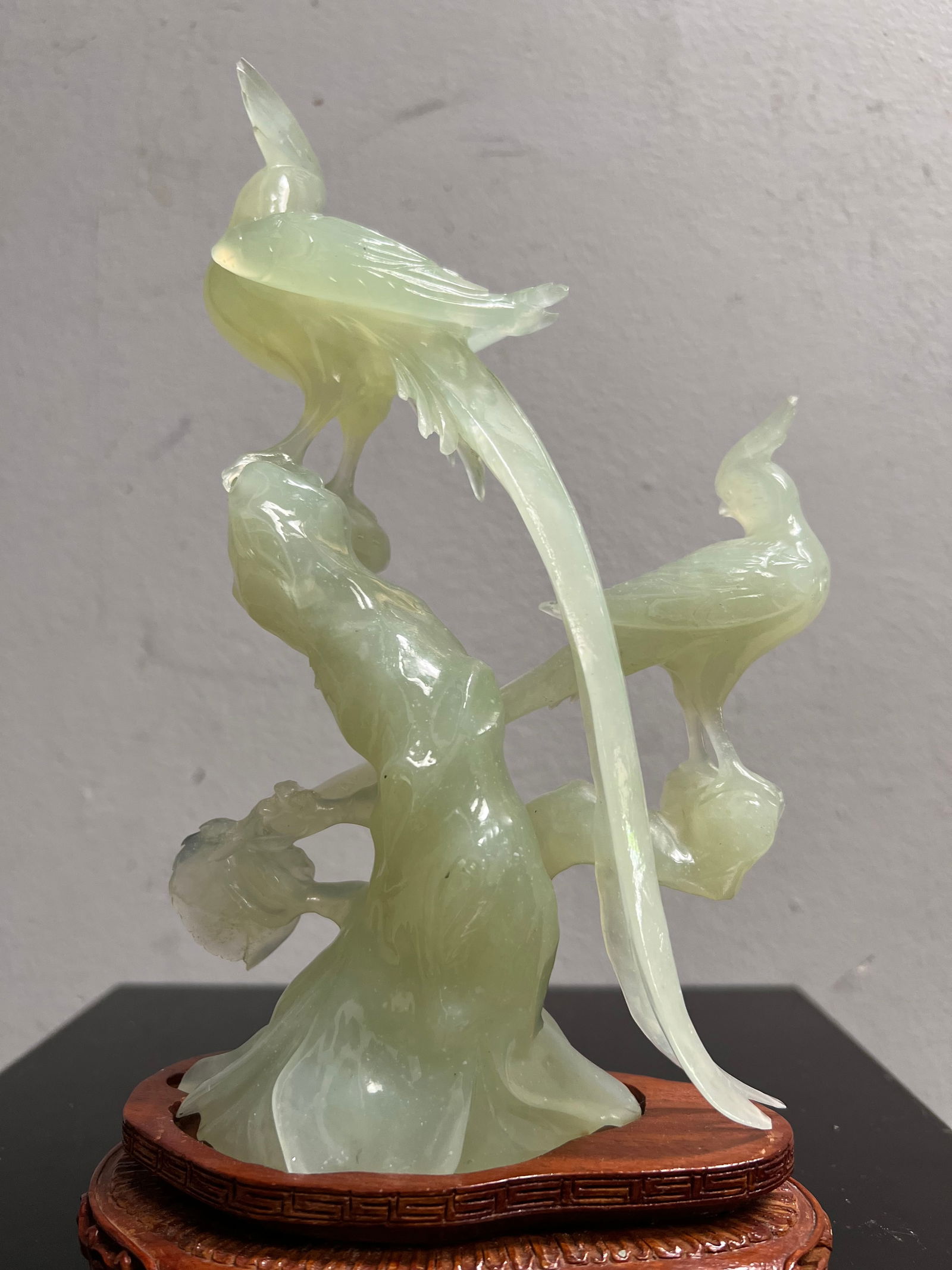 Stunning Chinese Hand Carved Green Jade Birds on a Tree on Wood Base: This exquisite piece is a stunning example of Chinese artistry. Hand-carved green jade birds perch upon a tree, surrounded by intricate details and a wooden base. The figurine is a post-1940 antique o