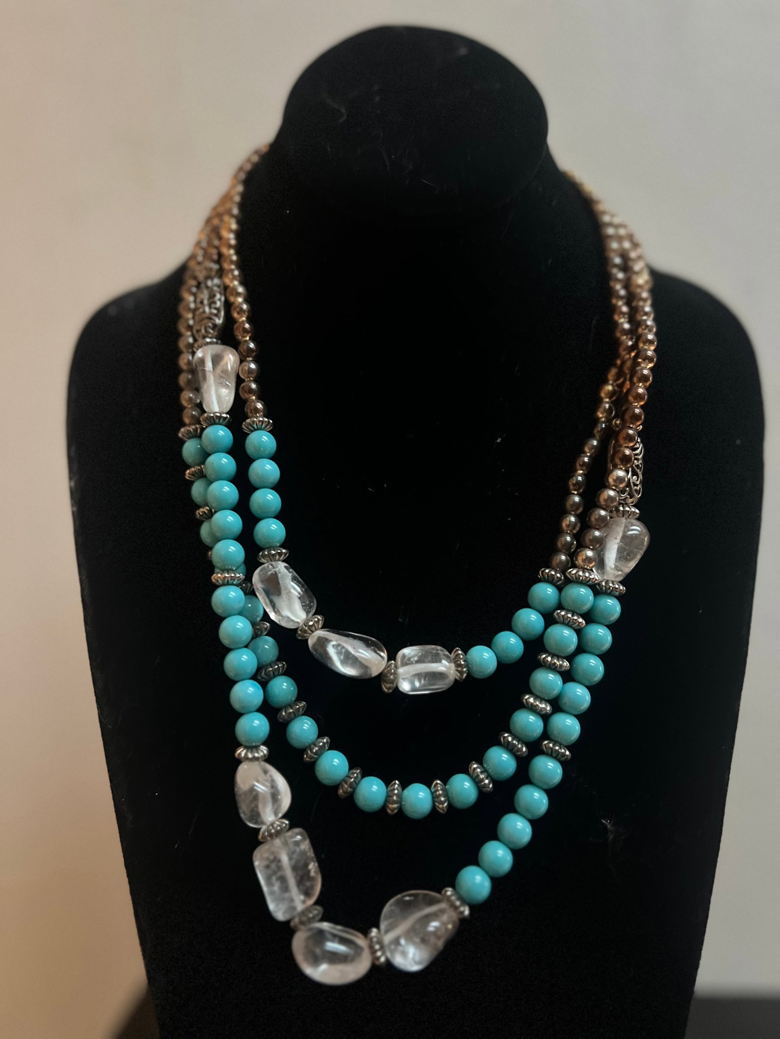 Vintage Glass Beed Necklace: Elevate your jewelry collection with the timeless elegance of this Vintage Glass Beaded Necklace. Featuring a delicate array of tan and blue glass beads, this piece exudes a classic charm that's versa