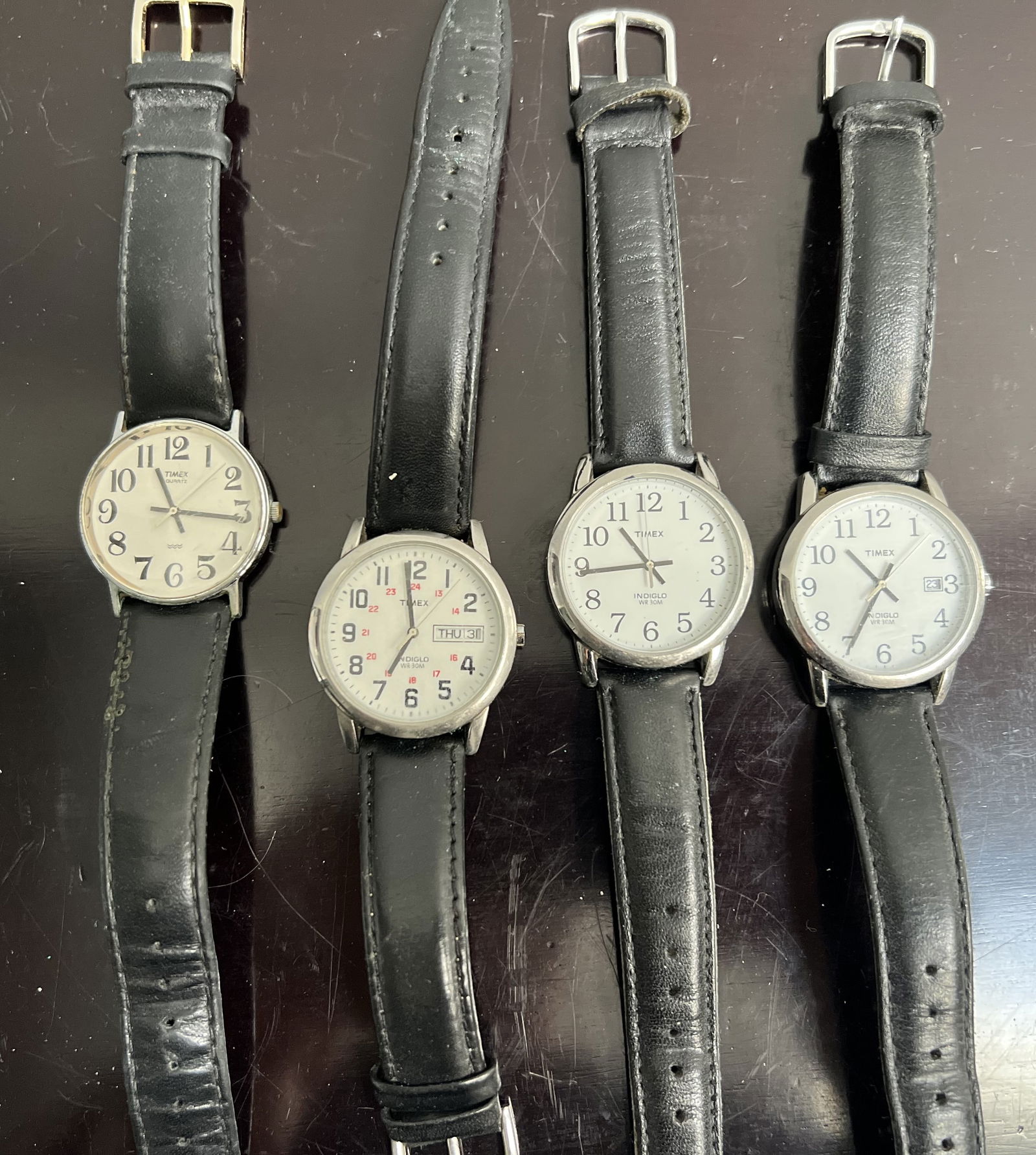 Collection of Four Timex Watches: Explore the timeless elegance of the Timex brand with this collection of four watches, each boasting a classic silver hue that complements any ensemble. Perfect for those who appreciate the simplicity