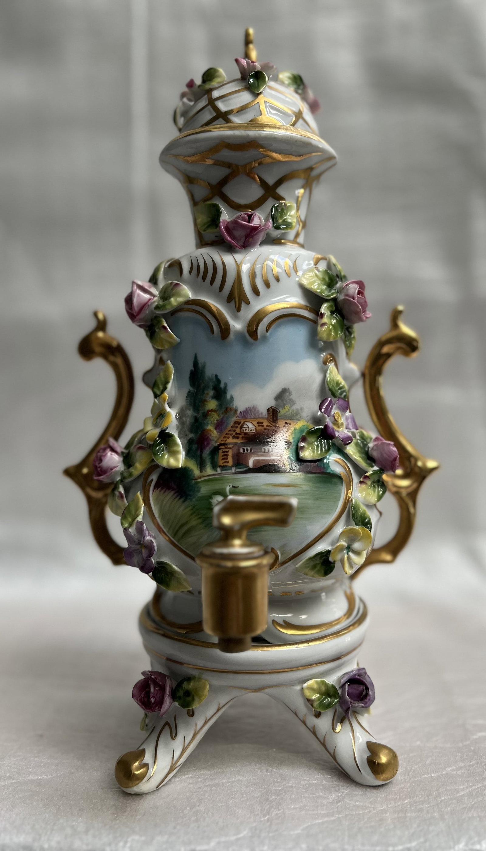 Porcelain Samovar Made in France Decorted with Floral Motifs, Gold Accents: This exquisite porcelain samovar is a true masterpiece. Crafted in France, it features stunning floral motifs and gold accents that add a touch of elegance to any room. Measuring 12 inches in height a