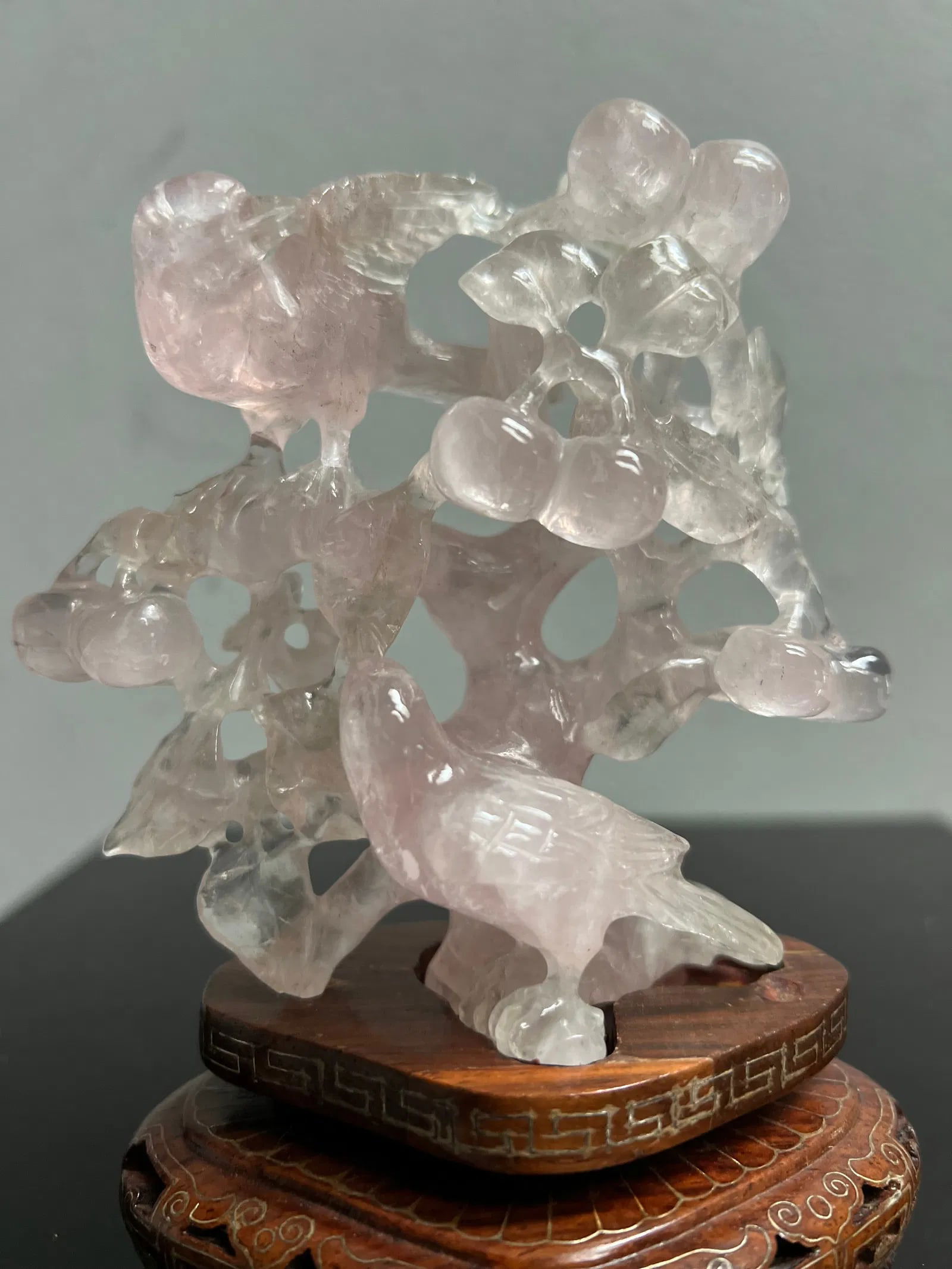 Stunning Chinese Hand Carved Light Pink Jade Birds in a Tree on Wood Base: This exquisite Chinese hand-carved figurine is a true antique original. The delicate pink jade statue depicts a beautiful bird sitting atop a tree, with intricate details carved into the wood base. Th