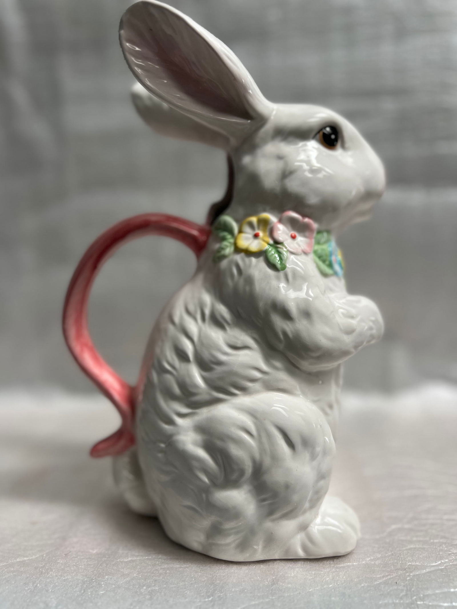 White Rabbit Ceramic Pitcher Hand Painted: Crafted with care, this ceramic pitcher showcases a charming white rabbit motif, hand-painted to bring a touch of whimsy to your home. The piece is a genuine original from the 1980s, embodying the sty
