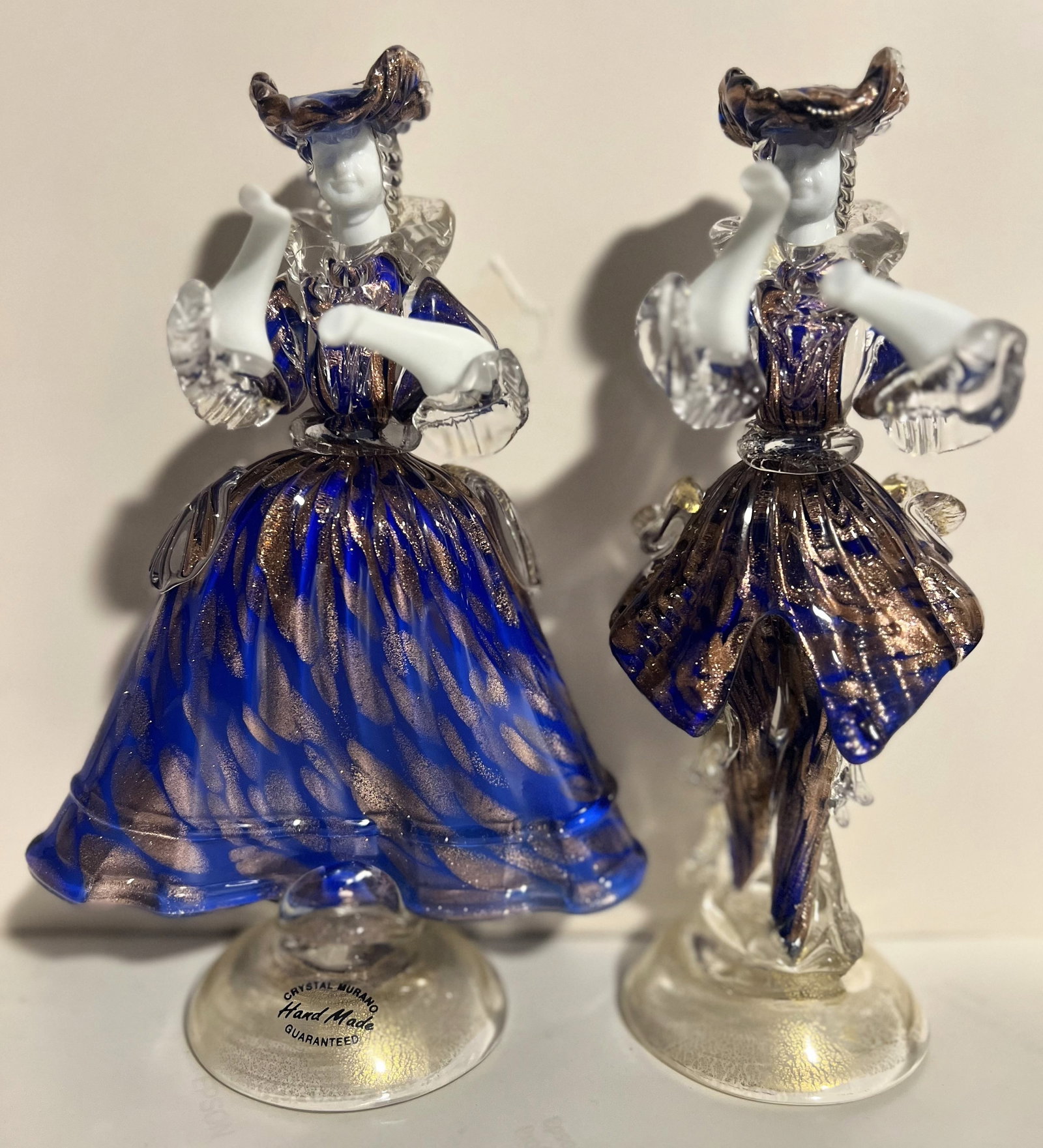 Pair of Murano Goldoni Statues couple Mid Century: This product is a pair of Murano Goldoni statues, a Victorian couple hand-blown from colorful glass in Italy. Standing at 8 inches tall and 6 inches wide, these original collectibles make a charming a