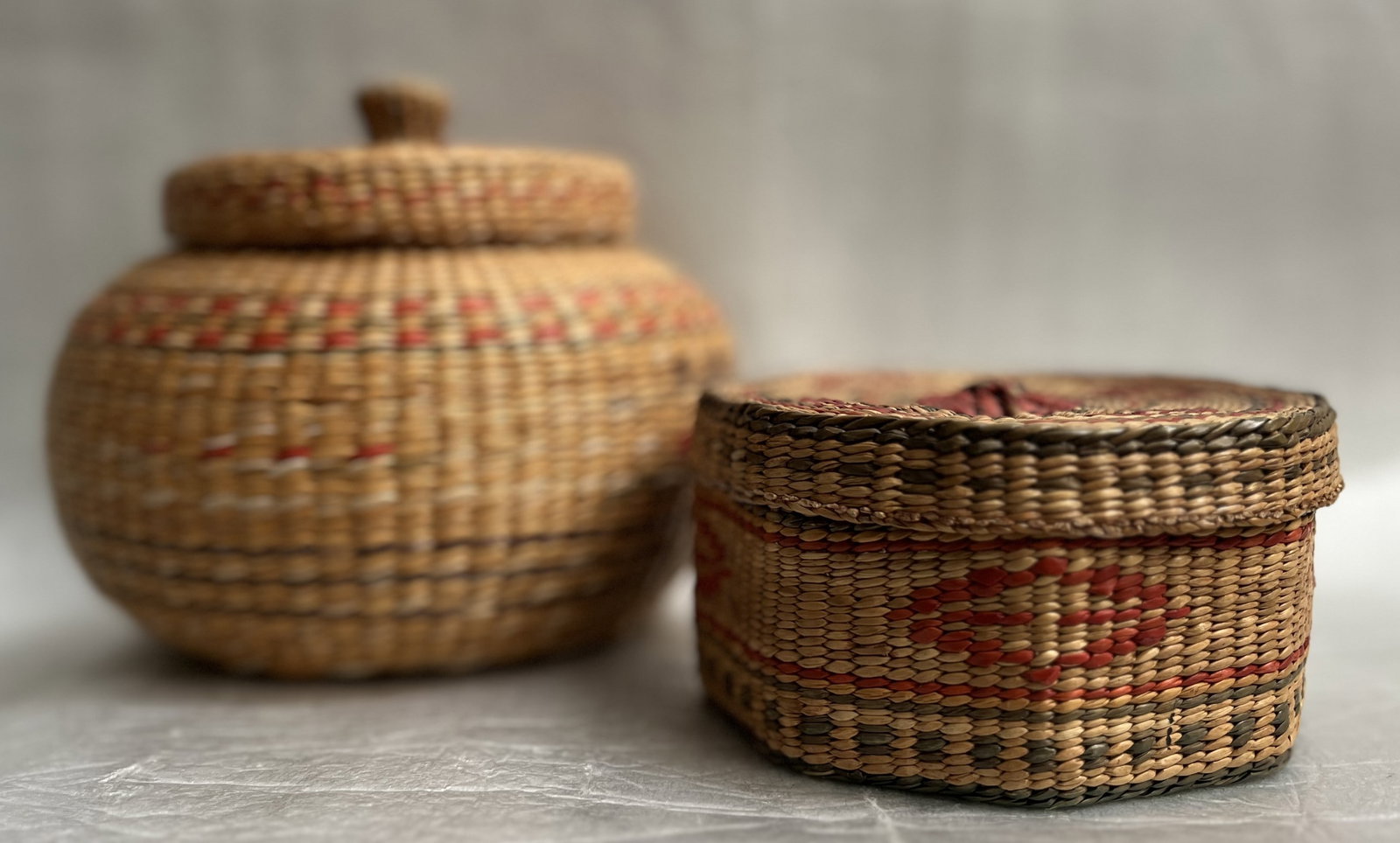 Pair of Native American Woven Baskets C Mid Century: The product is a pair of handmade Native American woven baskets from the mid-20th century, originating from the United States. These baskets showcase traditional Native American design and craftsmansh