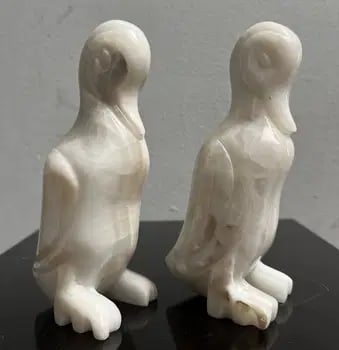 A Pair of Carved Marble Statues: Experience the elegance of Art Deco with this pair of carved marble statues, each depicting a graceful duck . Crafted with meticulous attention to detail, the sculptures bring a touch of sophisticatio
