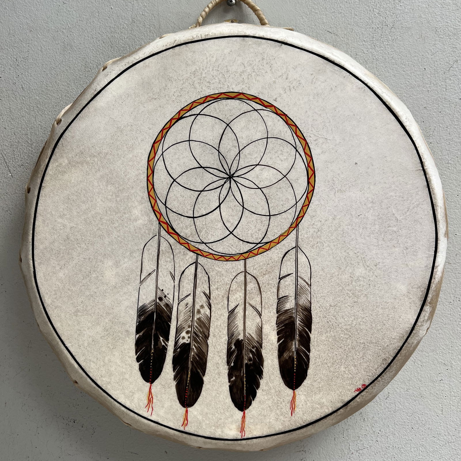 Nativan American Dream Catcher Drum 21 x 21: The Nativan American Dream Catcher Drum is a 21 x 21 musical instrument that embodies the spirit and craftsmanship of Native American culture in the United States. Made in the Midwest, this drum incor
