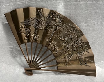 Vintage decorative fan, likely made of solid brass , featuring a raised relief design