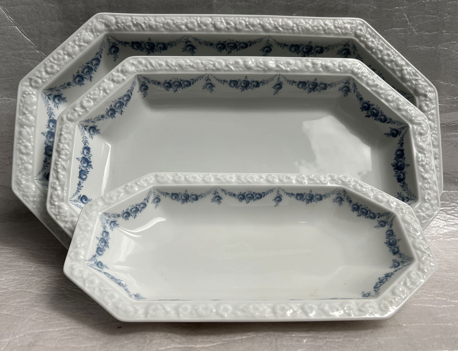 Set of 3, 15" 13" & 10" Serving Platters Vintage Rosenthal Maria Porcelain Circa 1960s: Product: Rosenthal Maria porcelain dinnerware, specifically the "Maria Rosenkante Blau" or "Dream Blue" pattern. Design: Features a polygonal shape with a characteristic embossed fruit wreath rim and